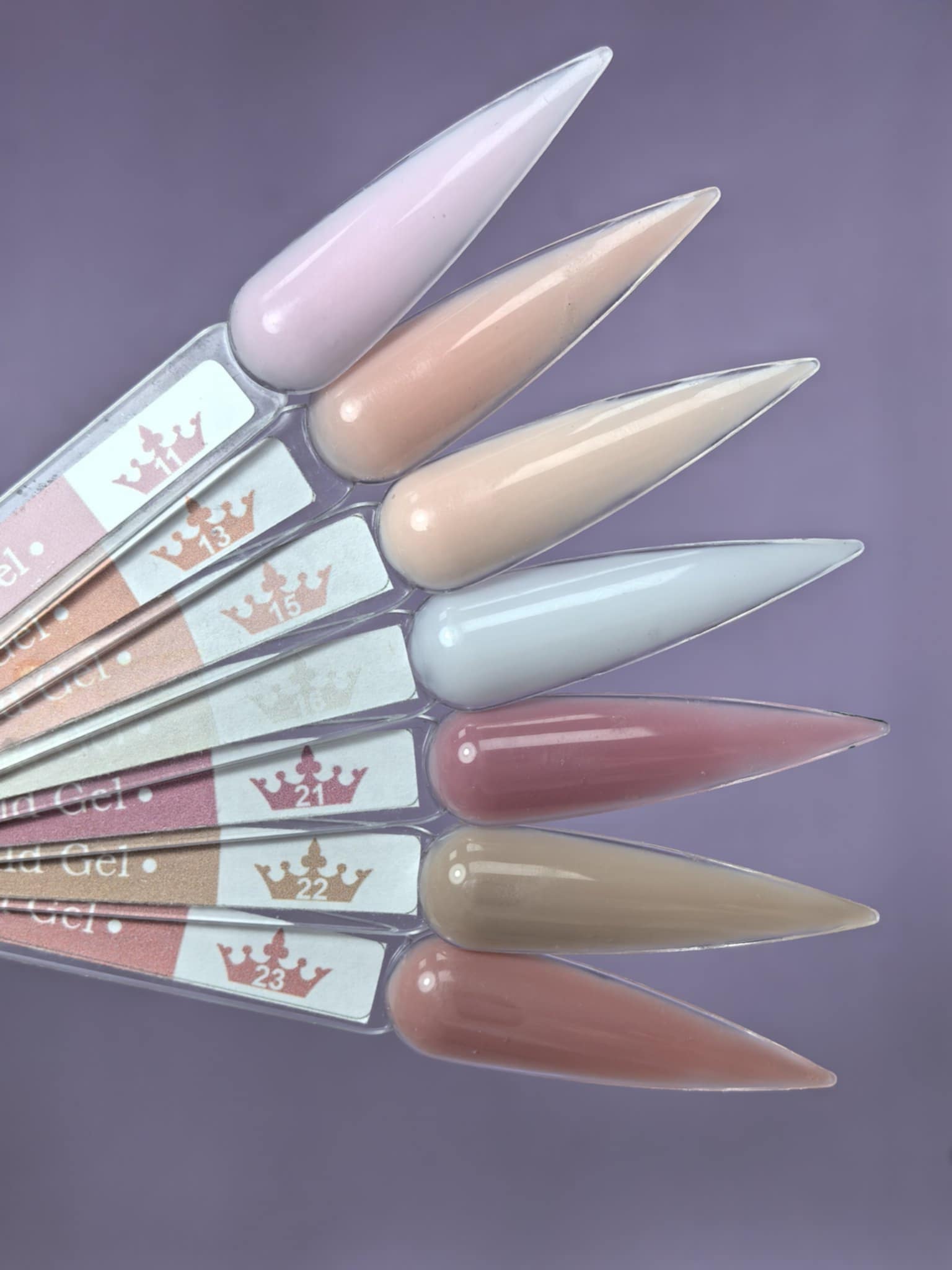 Variety of nail colors on display including Lemmy Builder Gel 15 - Malibu Peach 15ml, ideal for natural nails and salon lengths.