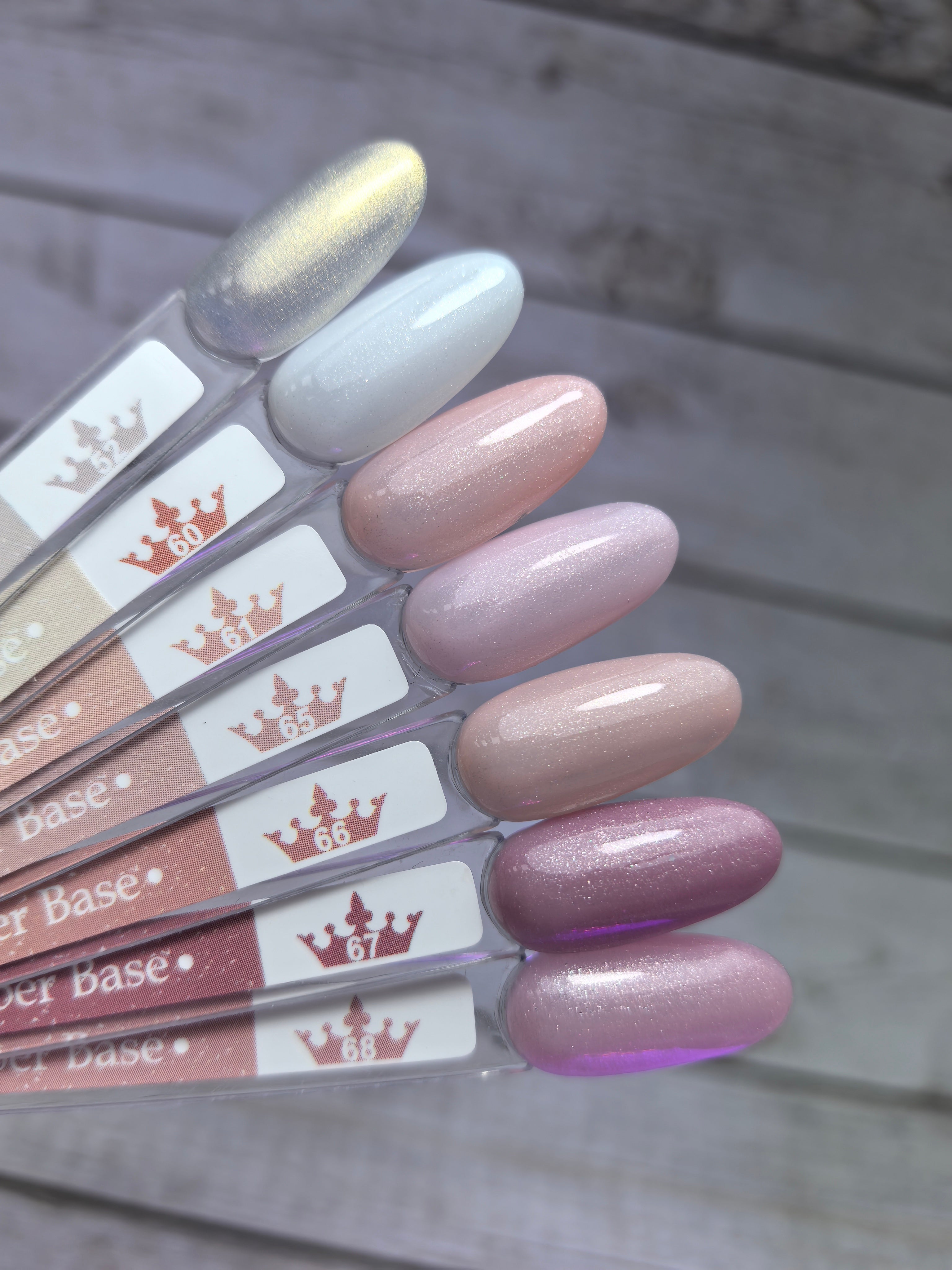Assorted shades of Nude Rubber Base 60 on display, showcasing medium viscosity and pigmentation for nail applications.